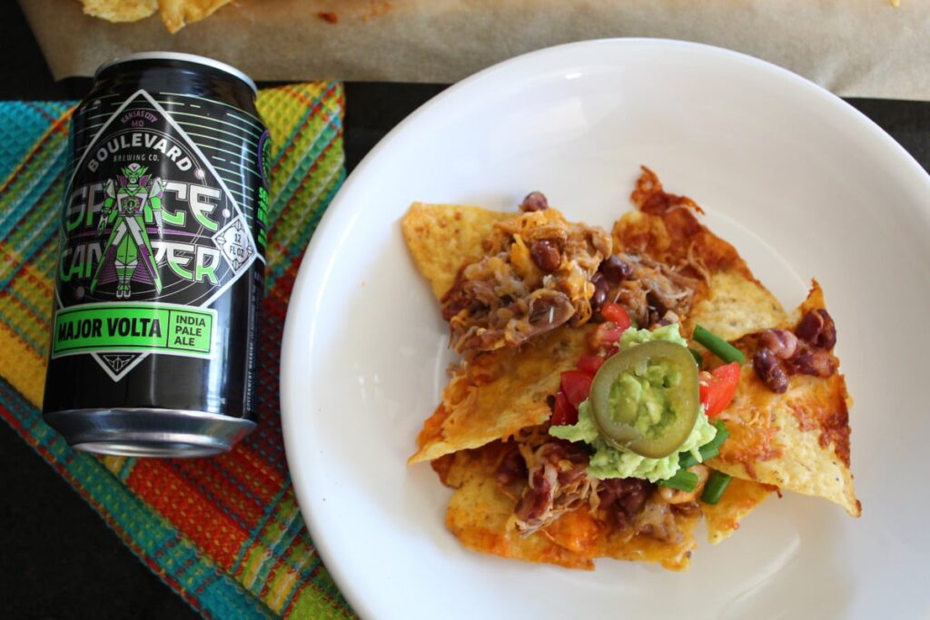 overhead shot of loaded pork nachos with a craft beer pairing.