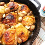 Overhead shot of Skillet Chicken, Mushrooms & Garlic. with a craft beer off to the side.