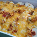 side shot of chicken burritos in a baking dish.