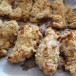 side shot of stuffing chicken breast recipe on parchment paper.