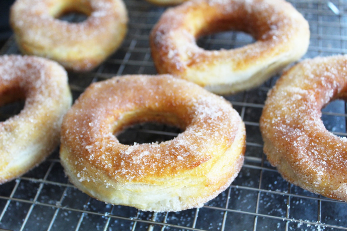 A close up of air fryer donuts cooling on a rack.