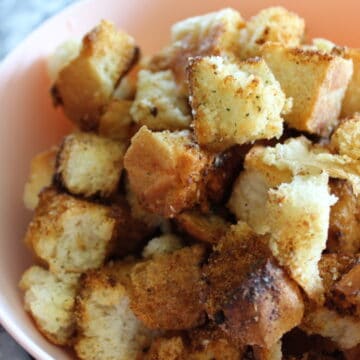 side view of air fryer ranch croutons in a bowl