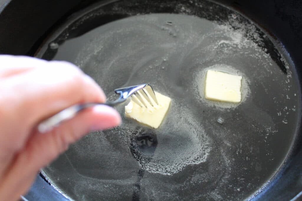 overhead shot of butter in a cast iron skillet