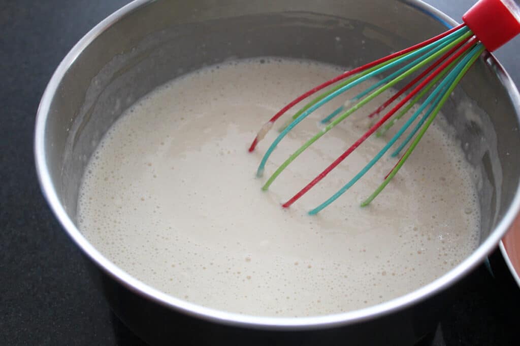 batter for Swedish Pancakes in a bowl with a whisk in it