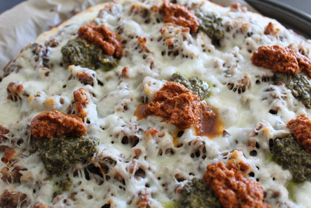 sun dried tomato and basil pesto on a white sauce pizza recipe.