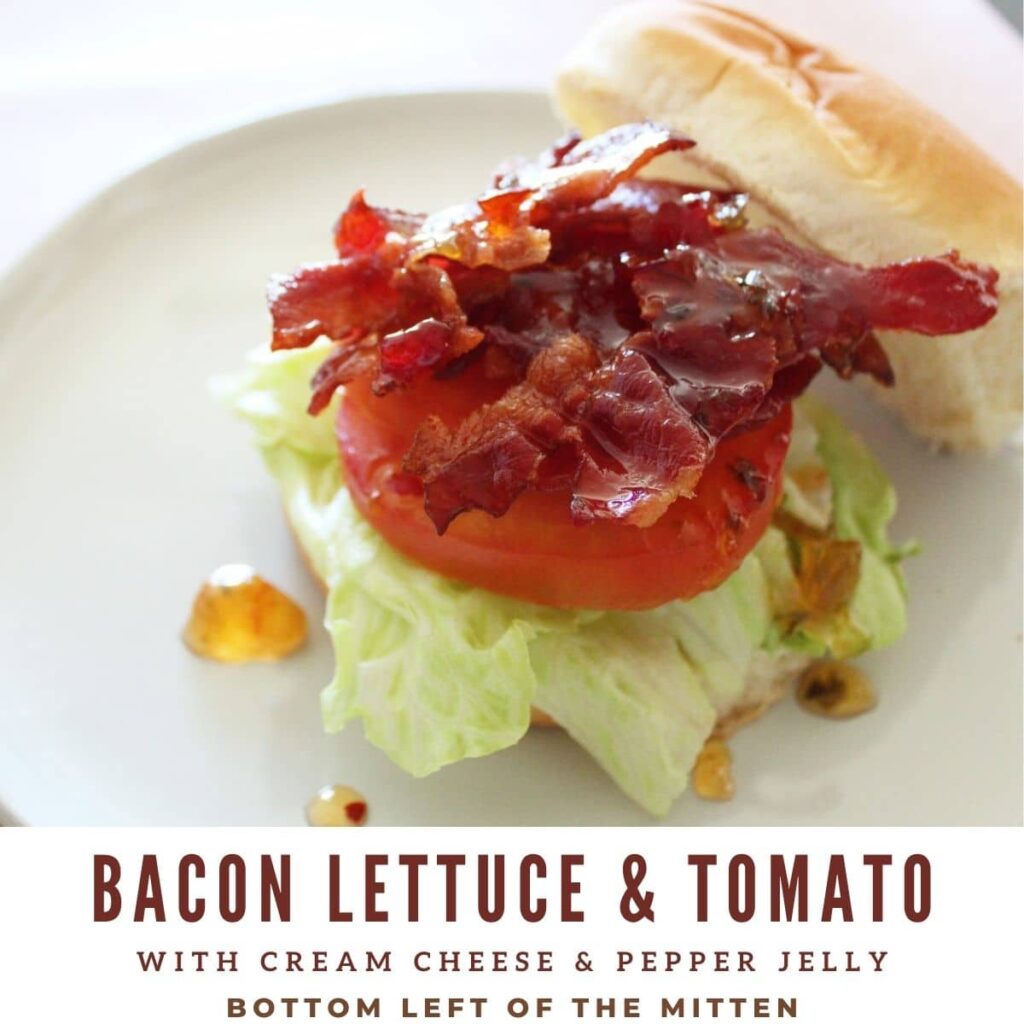 bacon lettuce and tomato with jelly on a bun. text 'bacon lettuce and tomato with pepper jelly and cream cheese' and 'bottom left of the mitten' under picture.